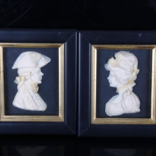 1335 - Leslie Ray, a pair of wax relief portraits in ebonised and gilded frames, overall frame dimensions 1... 