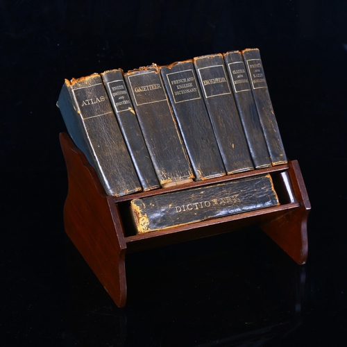 1344 - An Asprey's mahogany desk-top book rack, circa 1900, containing original set of leather-bound refere... 