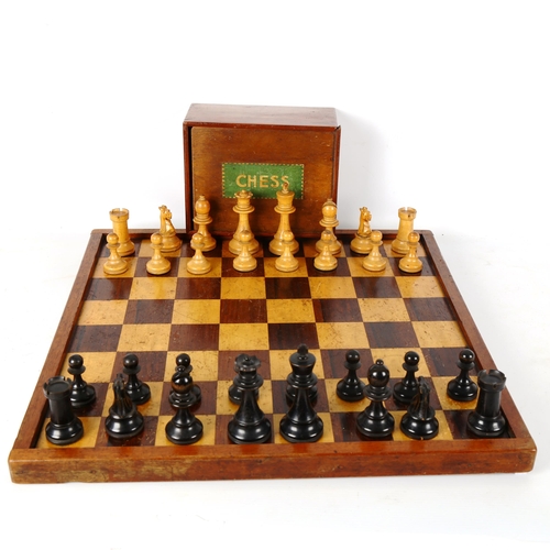 1345 - A Staunton pattern boxwood and ebonised chess set, with weighted pieces, King height 9cm, no maker's... 