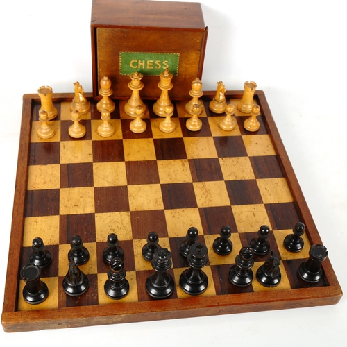 1345 - A Staunton pattern boxwood and ebonised chess set, with weighted pieces, King height 9cm, no maker's... 