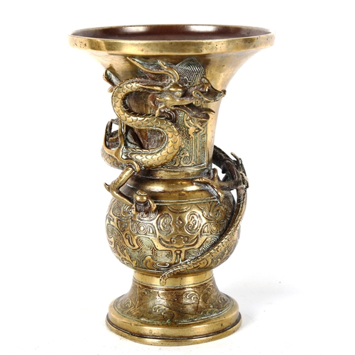 1348 - A Chinese polished bronze vase, with dragon entwined neck and relief decoration, height 21cm, rim di... 