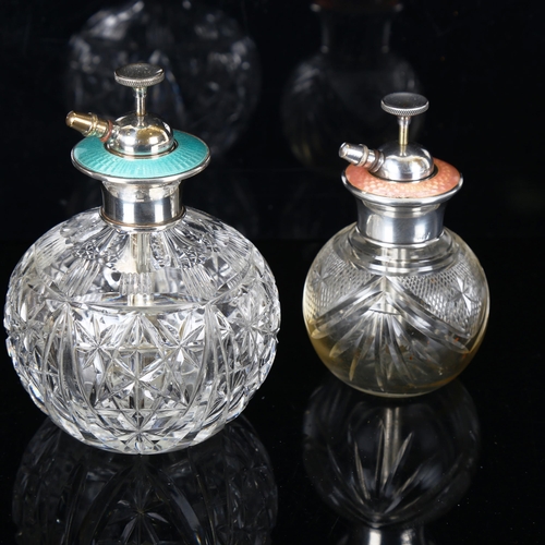 1349 - 2 cut-glass atomiser perfume bottles, with silver and enamel tops, largest height 13cm