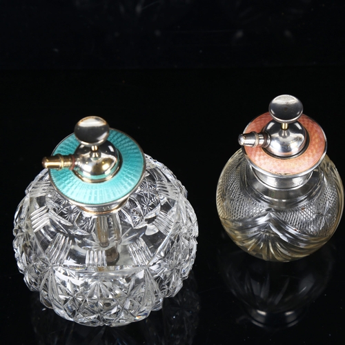 1349 - 2 cut-glass atomiser perfume bottles, with silver and enamel tops, largest height 13cm