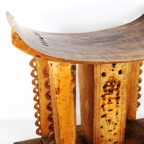 1354 - A large Ashanti Chief's stool, carved from a single piece of timber, with pierced decoration, probab... 