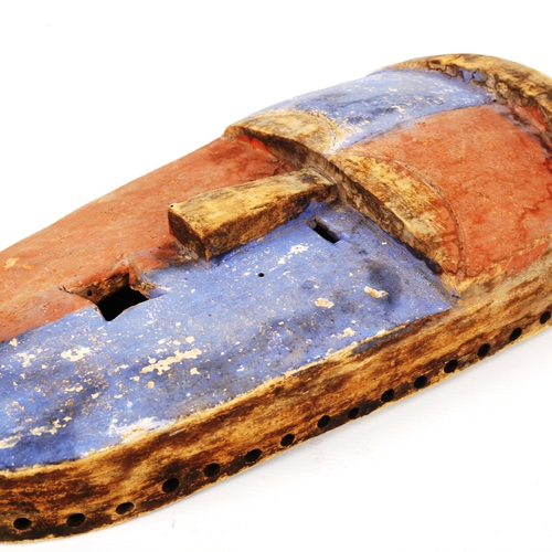 1356 - An African carved and painted wood flat-faced mask, with quartered blue and red decoration, length 4... 