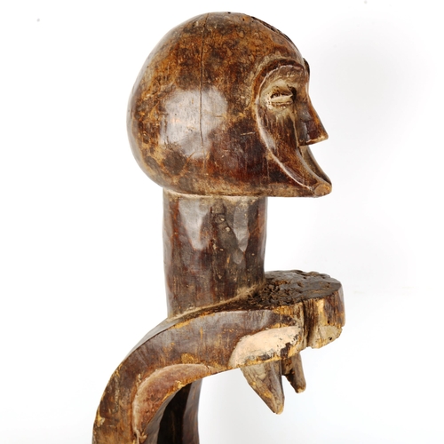 1362 - An African carved and stained wood stylised figure, height 71cm