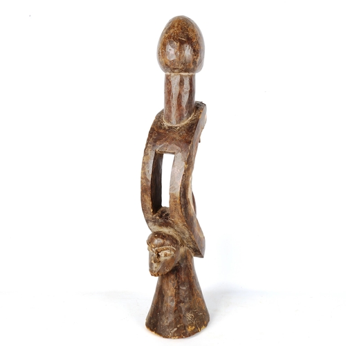 1362 - An African carved and stained wood stylised figure, height 71cm