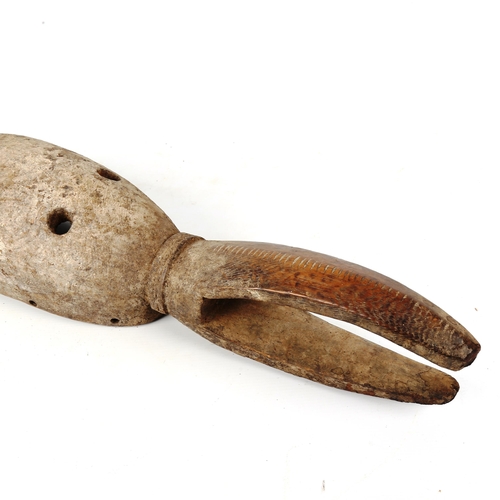 1364 - An African carved and painted wood lega horned mask, length 74cm