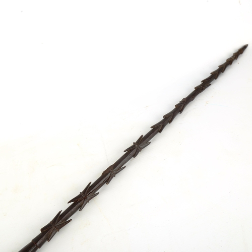 1372 - A Samoan hardwood spear, carved with rows of barbs, first half 19th century, length 210cm