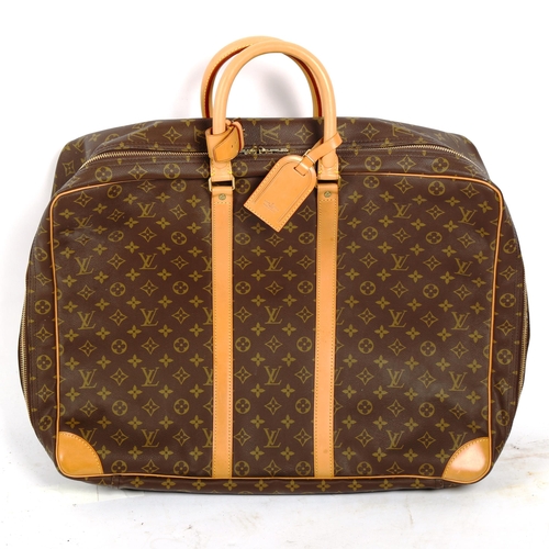 1382 - LOUIS VUITTON - a Monogram travelling case, with tan leather straps and handles, length approx 54cm,... 