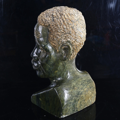 1427 - An African carved soapstone life-size head of a man, unsigned, height 36cm