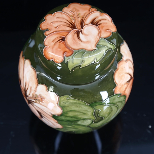 1429 - MOORCROFT POTTERY - a coral Hibiscus pattern ginger jar and cover, original paper label, height 15.5... 