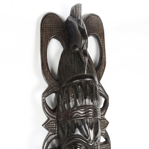 1433 - A large African carved ebonised wood mask, height 110cm