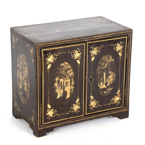 1441 - A Japanese gilded and ebonised table cabinet of small size, 2 doors enclosing 4 drawers, allover pai... 