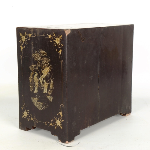 1441 - A Japanese gilded and ebonised table cabinet of small size, 2 doors enclosing 4 drawers, allover pai... 