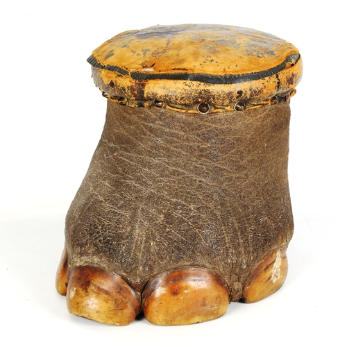 1443 - TAXIDERMY - an elephant's foot stool with original leather upholstered seat, height 30cm