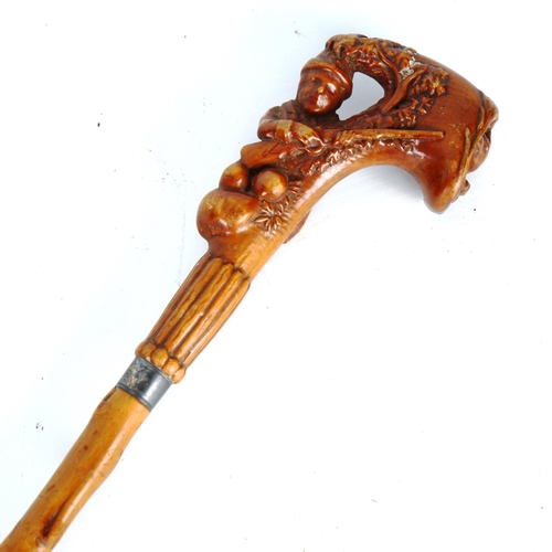 1450 - A 19th century horn-handled walking cane, in the form of a huntsman and rifle