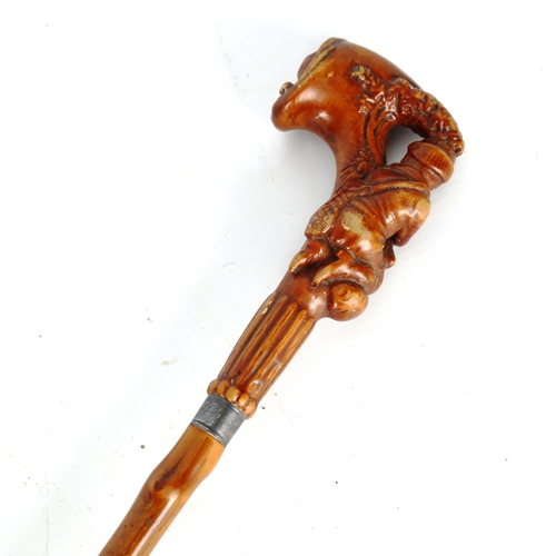 1450 - A 19th century horn-handled walking cane, in the form of a huntsman and rifle