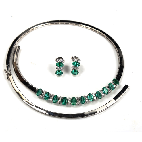 725 - A modern 18ct white gold emerald and diamond matching necklace and earring set, set with oval mixed-... 