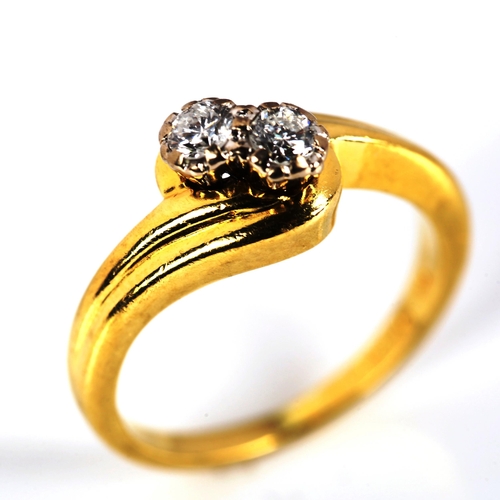 729 - A modern 18ct gold two stone diamond crossover ring, set with modern round brilliant-cut diamonds, t... 