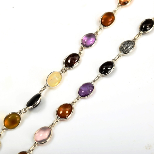 734 - A modern sterling silver graduated gem set line necklace, set with oval cabochon gemstones, to inclu... 