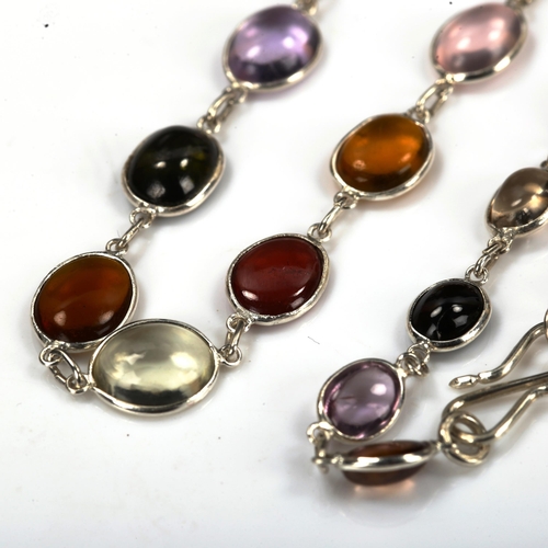 734 - A modern sterling silver graduated gem set line necklace, set with oval cabochon gemstones, to inclu... 