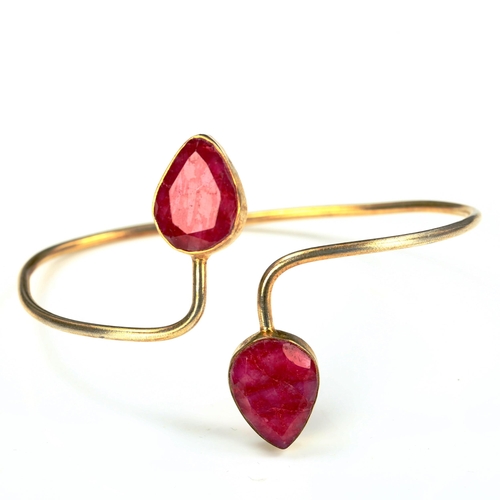 736 - A modern unmarked silver-gilt ruby torque bangle, internal measurements 6.5cm x 5cm, 12.1g