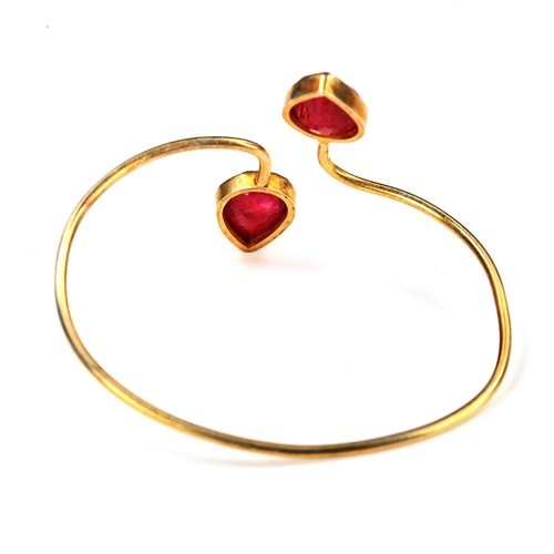 736 - A modern unmarked silver-gilt ruby torque bangle, internal measurements 6.5cm x 5cm, 12.1g