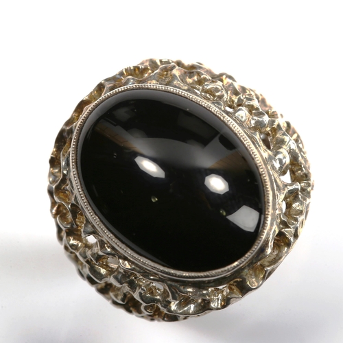 740 - A large 1970s silver onyx ring, pierced and textured organic form shoulders, hallmarks Birmingham 19... 