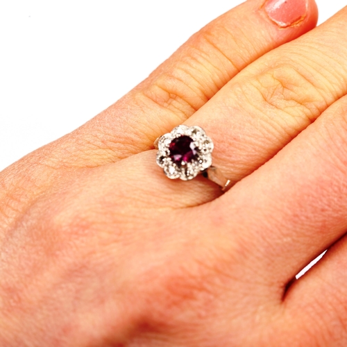 742 - An 18ct gold ruby and diamond cluster ring, set with round-cut ruby and single-cut diamonds, setting... 