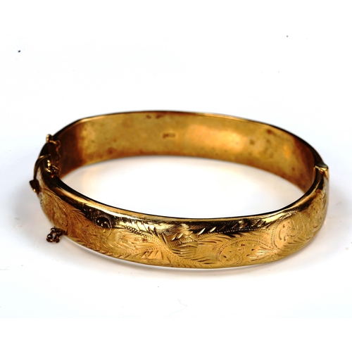 745 - A mid-20th century 9ct gold hinged bangle, engraved foliate decoration, maker's marks C and F, hallm... 