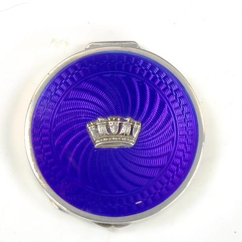 771 - A George V Art Deco silver and blue enamel Cinque Ports compact, circular form with engine turned gu... 