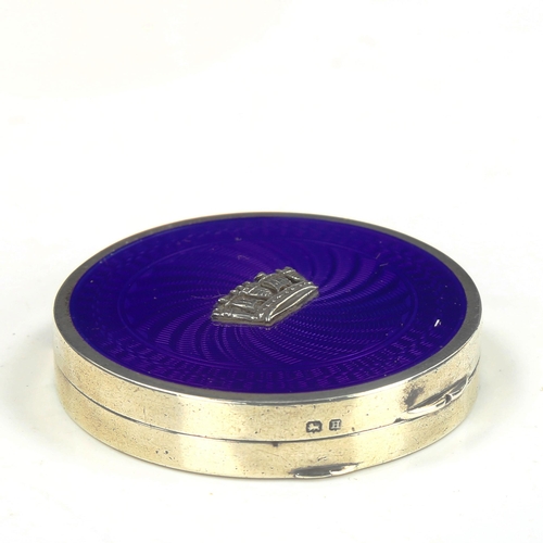 771 - A George V Art Deco silver and blue enamel Cinque Ports compact, circular form with engine turned gu... 