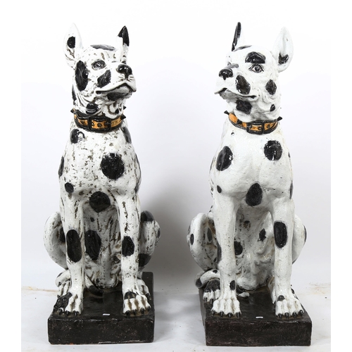 1241 - An impressive pair of life-size glazed pottery seated Dalmatian hounds with studded collars, probabl... 