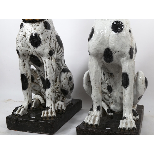 1241 - An impressive pair of life-size glazed pottery seated Dalmatian hounds with studded collars, probabl... 