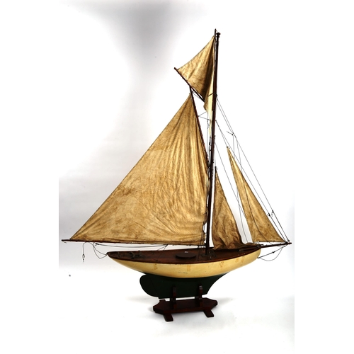 1248 - A large Vintage wood-hulled model pond yacht, with sails and rigging, on stand, total length approx ... 