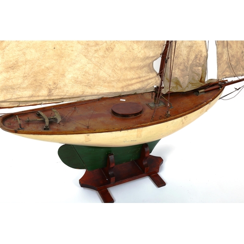 1248 - A large Vintage wood-hulled model pond yacht, with sails and rigging, on stand, total length approx ... 