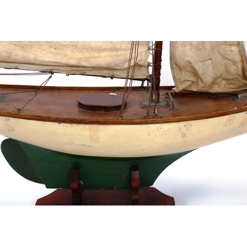 1248 - A large Vintage wood-hulled model pond yacht, with sails and rigging, on stand, total length approx ... 