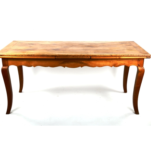 1412 - A French 19th century fruitwood extending draw leaf dining table, with plank top, scalloped shaped f... 