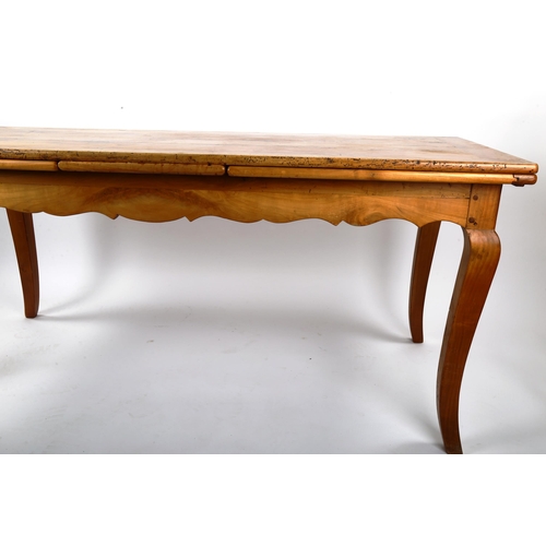 1412 - A French 19th century fruitwood extending draw leaf dining table, with plank top, scalloped shaped f... 