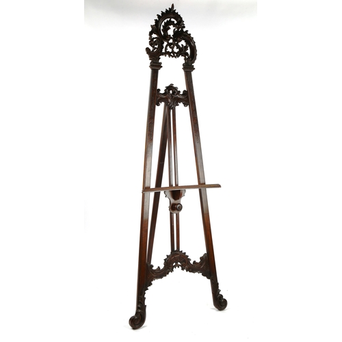 1413 - A 19th century mahogany display easel, with carved acanthus leaf decoration, height 2m