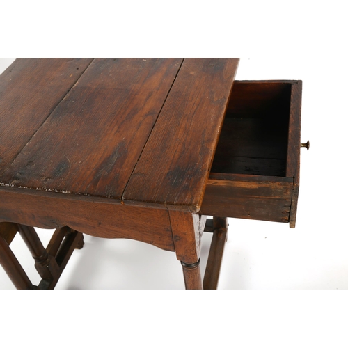 1415 - An unusual 18th century joined oak single drop leaf occasional table of small size, with single frie... 