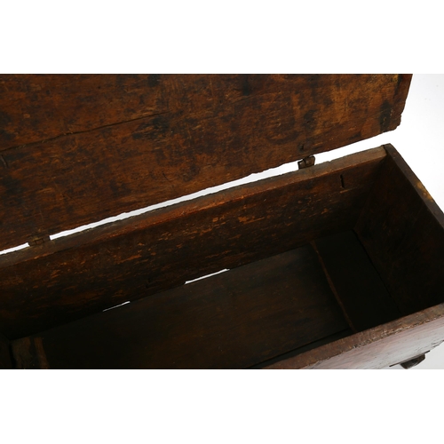 1416 - A 17th/18th century oak coffer of plank construction, with iron hinges, length 95cm