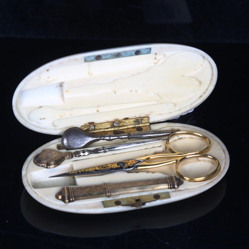 1528 - A French 19th century ivory etui, containing unmarked yellow metal needle case, gilded scissors etc,... 