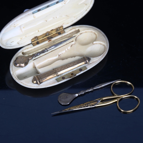 1528 - A French 19th century ivory etui, containing unmarked yellow metal needle case, gilded scissors etc,... 