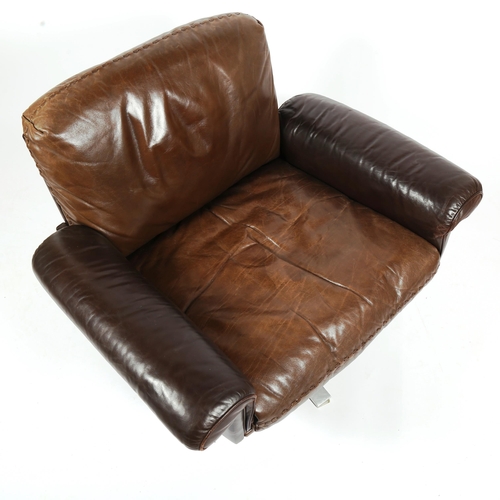 1818 - A 1970s' De Sede DS 31 lounge swivel chair, in brown leather, with aluminium base, height 75cm.