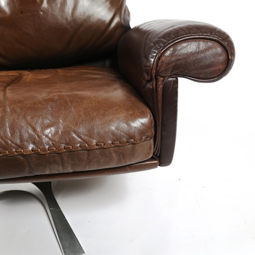 1818 - A 1970s' De Sede DS 31 lounge swivel chair, in brown leather, with aluminium base, height 75cm.