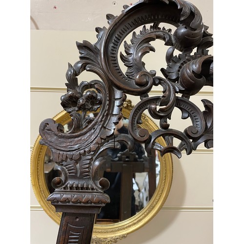 1413 - A 19th century mahogany display easel, with carved acanthus leaf decoration, height 2m