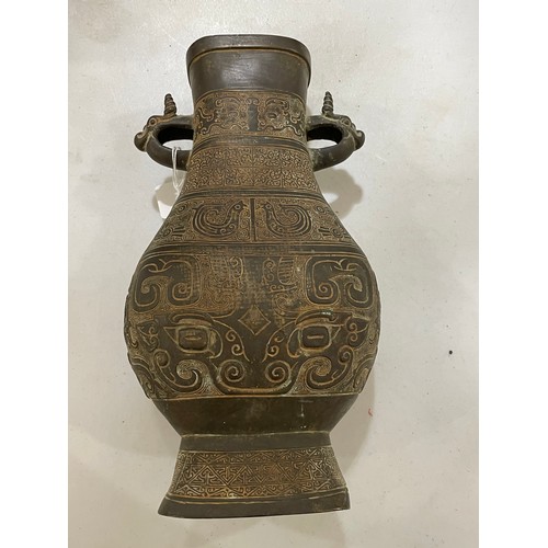 1006 - A Chinese Archaic style bronze vase, with relief decoration and dragon handles, height 30cm