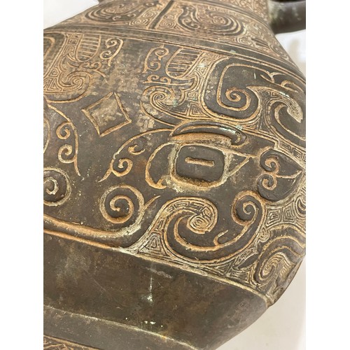 1006 - A Chinese Archaic style bronze vase, with relief decoration and dragon handles, height 30cm